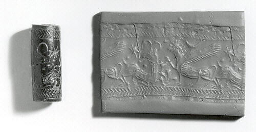 Cylinder seal (with pin preserved) with animal-monster contest scene, Black Steatite, with copper/bronze pin, Assyrian 