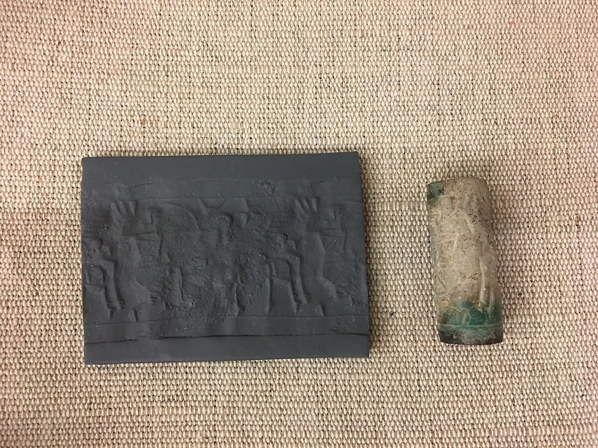 Cylinder seal with hunting scene, Beige fossiliferous Limestone, stained green at ends, Assyrian