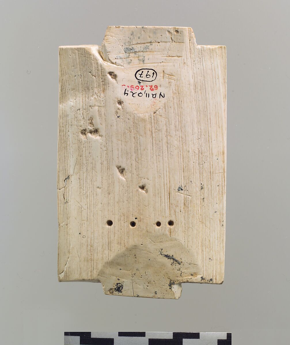 Furniture plaque carved in relief with a striding, ram-headed sphinx supported by two kneeling figures, Ivory, Assyrian