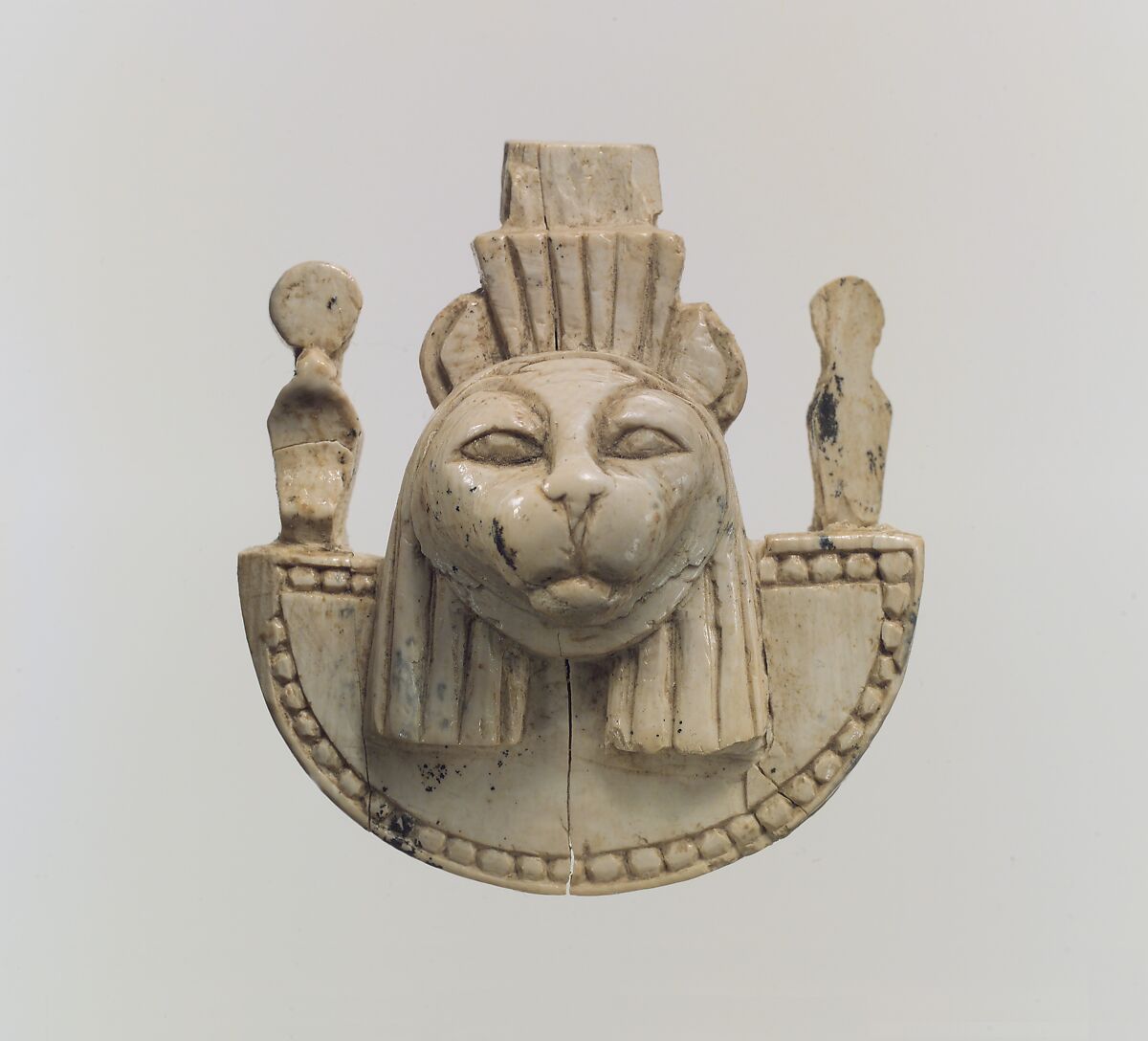 Openwork furniture plaque with the head of a feline, Ivory, Assyrian 