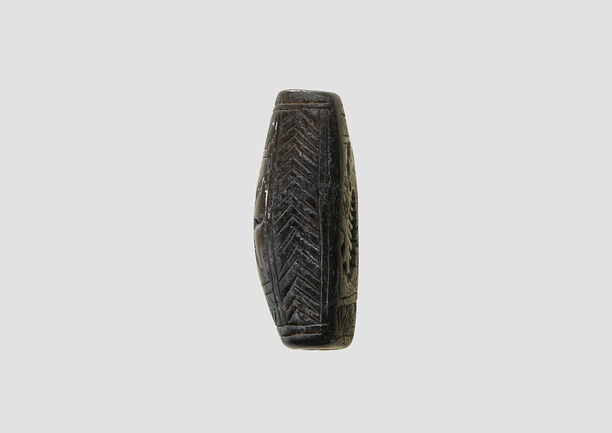 Stamp seal (loaf-shaped hemispheroid) with animal and symbol, Mottled gray Limestone, Assyrian