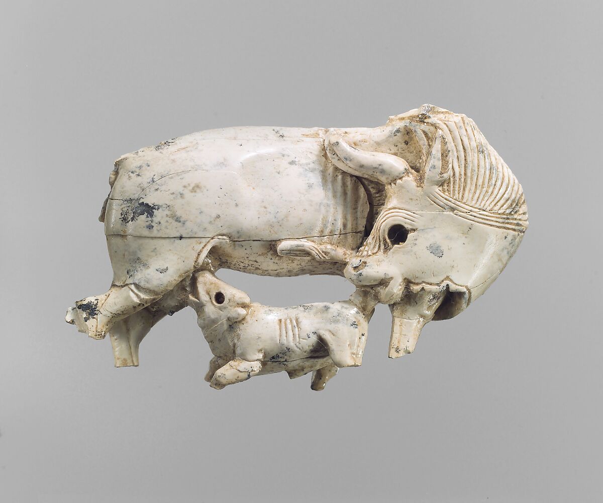 Openwork furniture plaque with a cow suckling a calf, Ivory, Assyrian