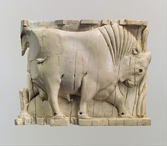 Furniture or cosmetic box plaque carved in relief with a striding bull