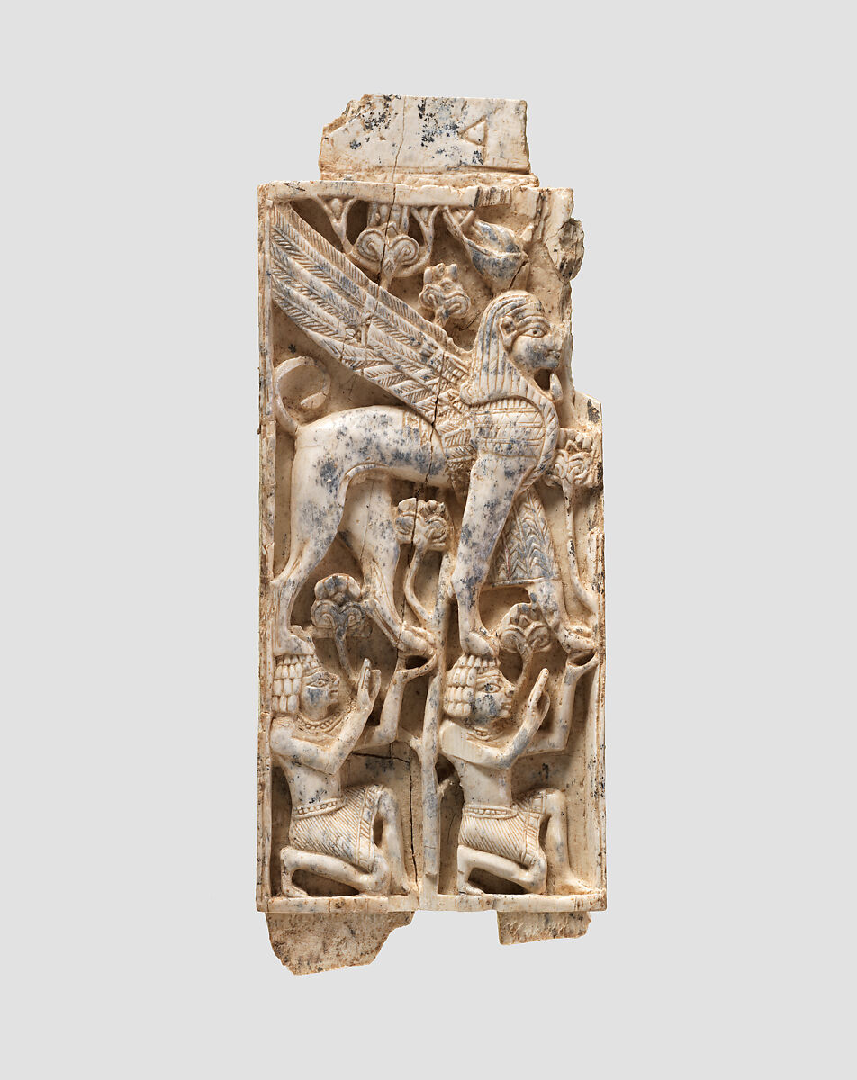 Furniture plaque carved in relief with a striding, falcon-headed winged ...