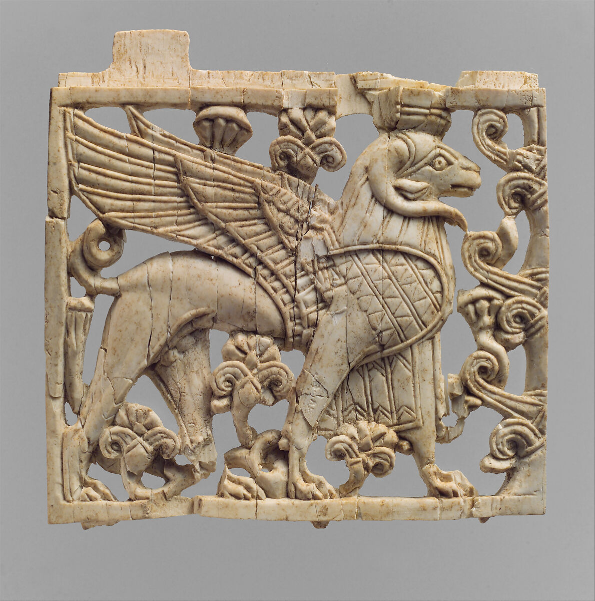 Openwork furniture plaque with a striding, ram-headed sphinx, Ivory, Assyrian 