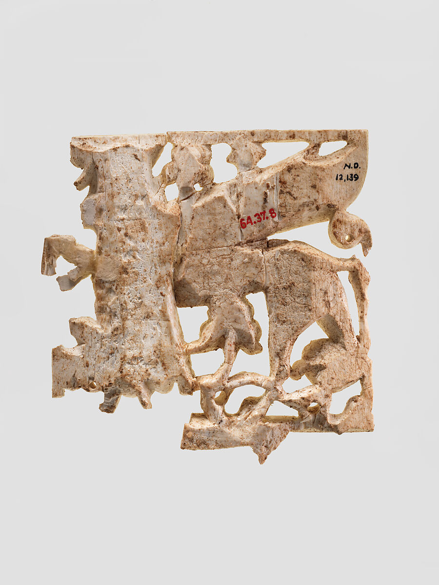 Openwork plaque with a sphinx striding through a floral landscape, Ivory, Assyrian