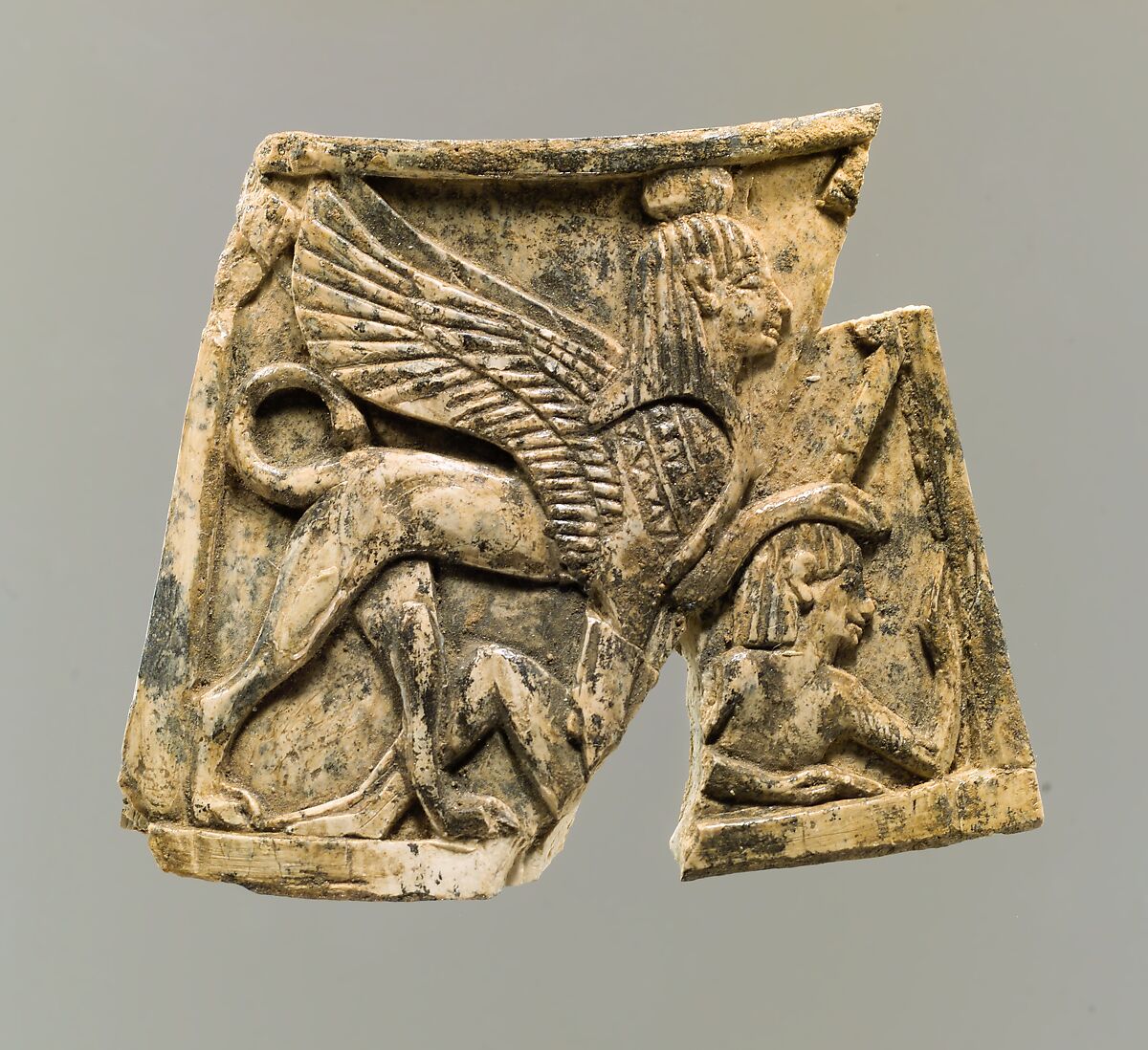 Plaque carved in relief with sphinx trampling figure, Ivory, Assyrian 