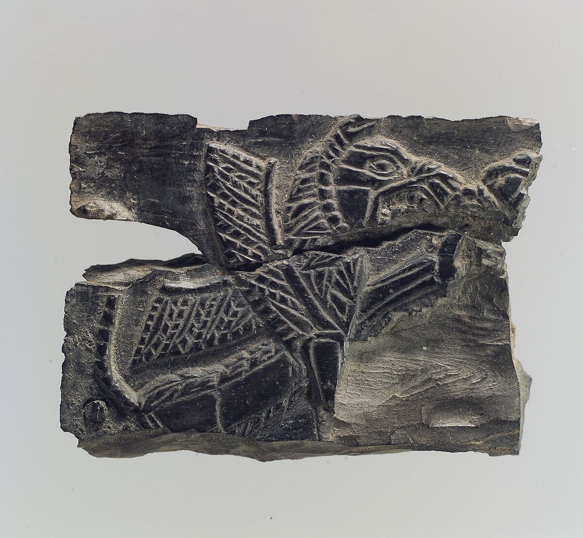 Plaque with a seated, winged leonine monster  possibly with scorpion tail, Ivory, Iran