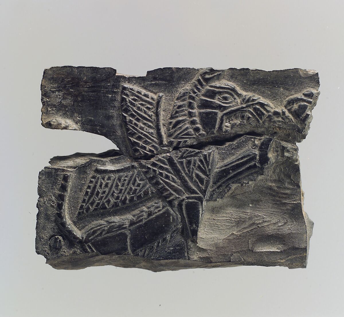 Plaque with a seated, winged leonine monster  possibly with scorpion tail, Ivory, Iran 