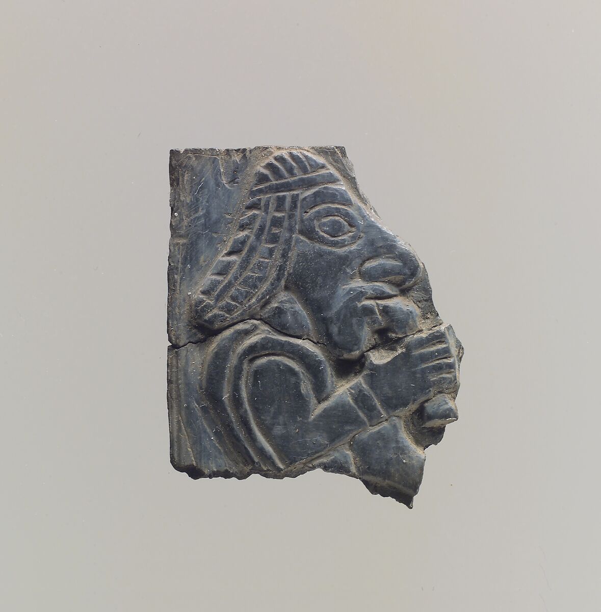 Furniture plaque carved in relief with man holding vessel to his mouth, Ivory, Iran