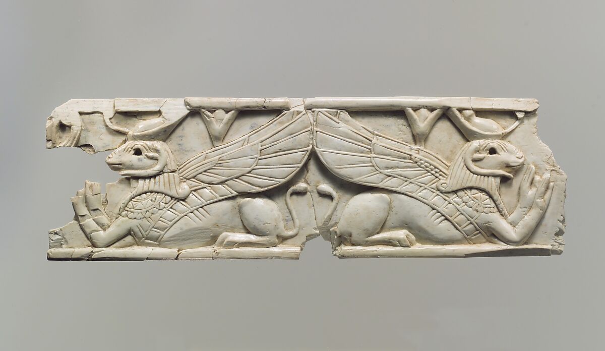 Furniture plaque carved in relief with two addorsed, ram-headed sphinxes, Ivory, Assyrian 