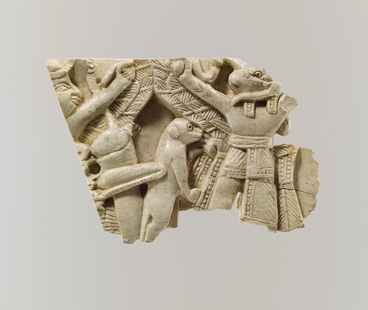 Furniture plaque carved in relief with winged figures, locust, and monkey, Ivory, Assyrian 