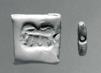 Rectangular plaque seal, indented at string holes, Chlorite or steatite, black 