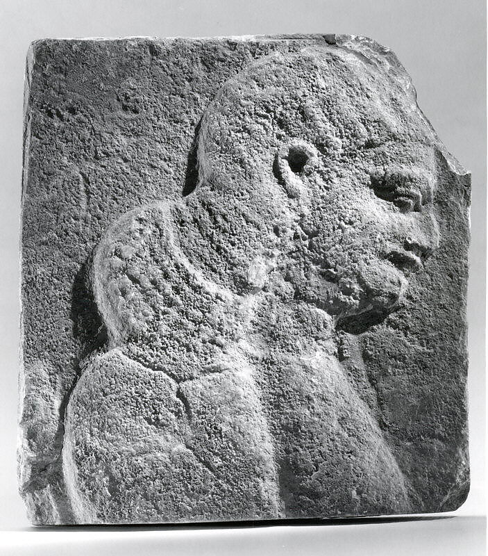Relief: head and shoulders of a beardless man, possibly a eunuch, Gypsum alabaster, Assyrian 