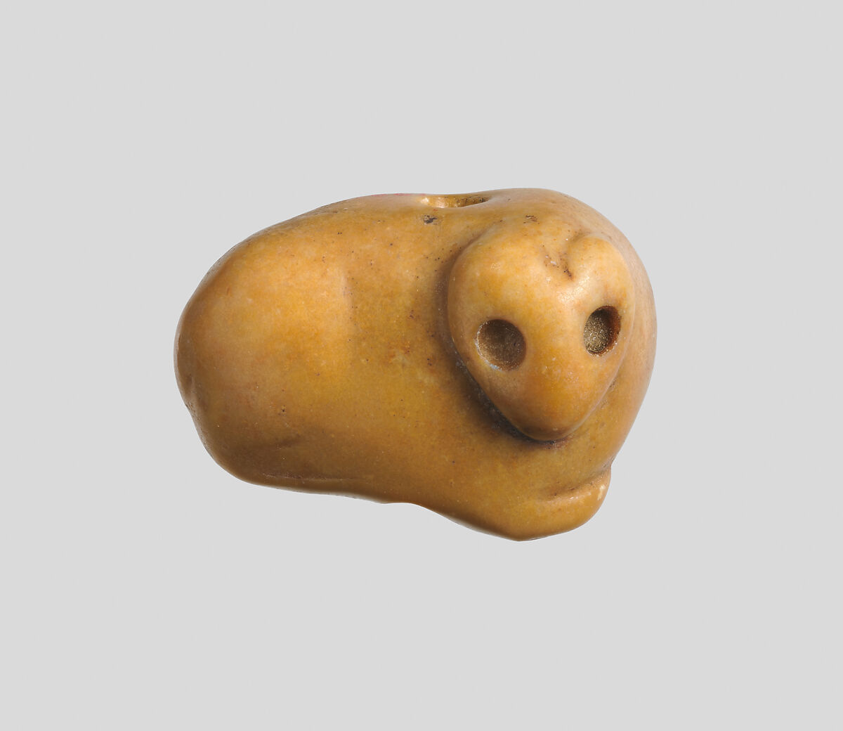 Seal amulet in the form of a recumbent fox, Marble, mustard color 