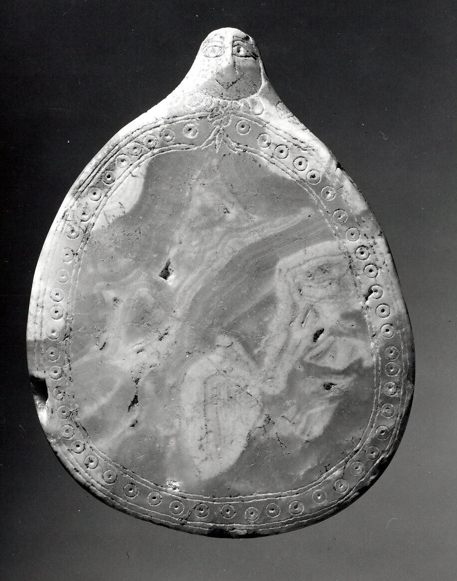 Palette with a sculpted female head and incised decoration, Calcite 