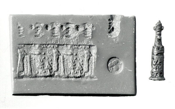 Stamp-cylinder seal with cultic scene, surmounted by (a plaster copy?) double-faced Pazuzu head 
