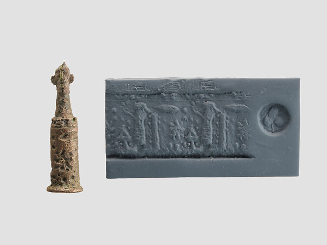 Stamp-cylinder seal with cultic scene, surmounted by (a plaster copy?) double-faced Pazuzu head 
