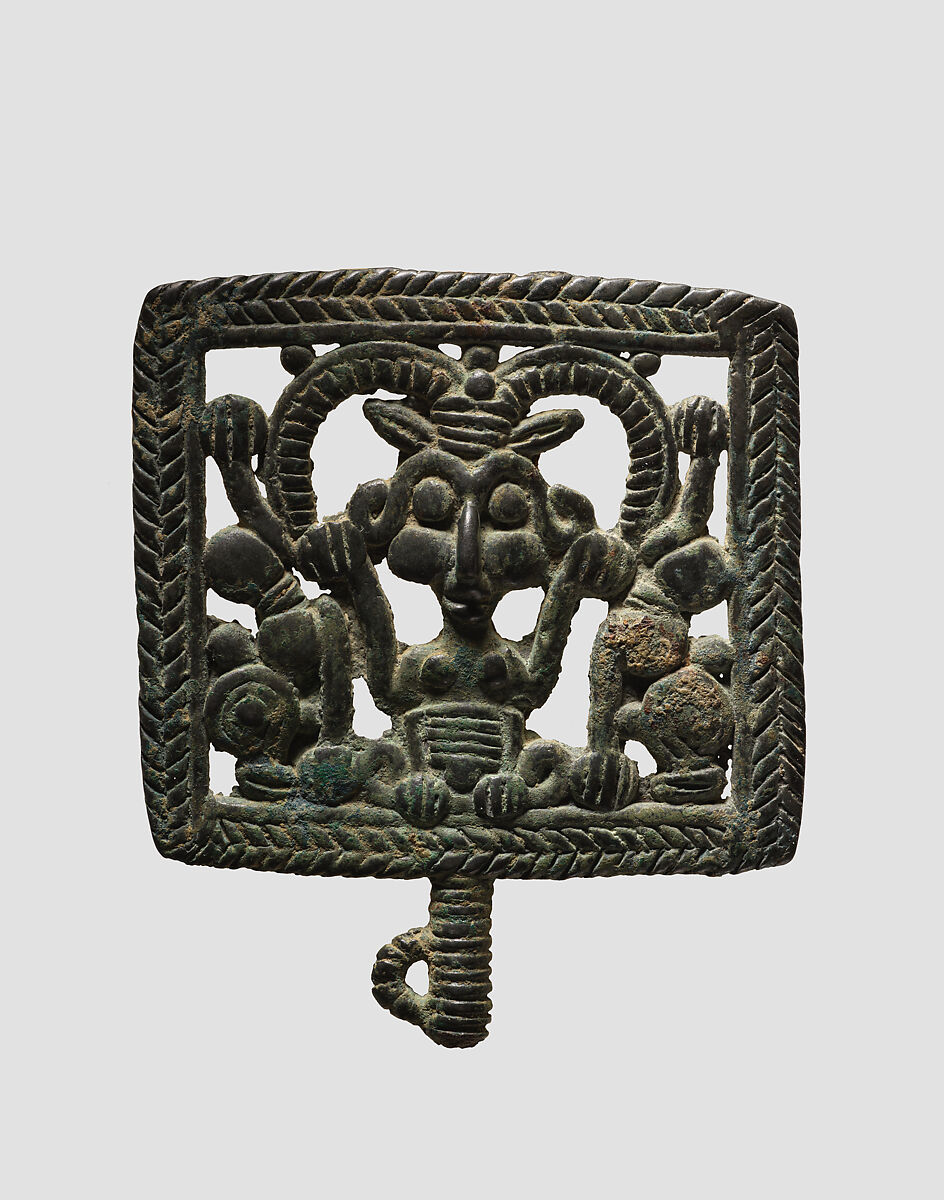Head of a pin: horned demon holding inverted lions, Bronze, Iran 