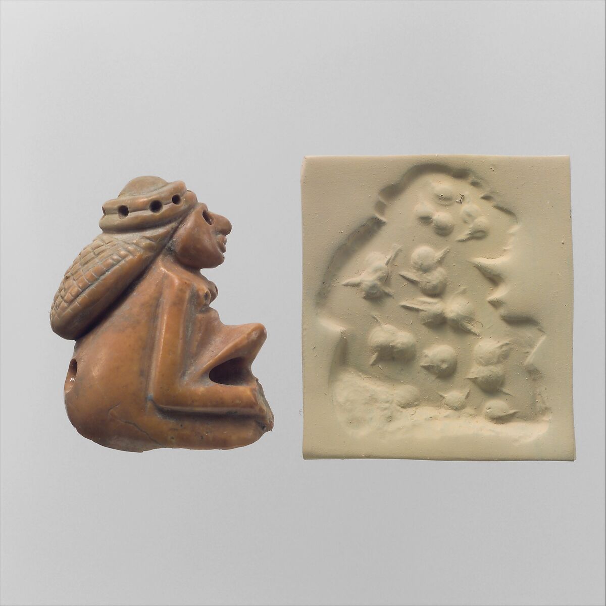 Seal amulet in the form of a seated female and modern impression, Rhodochrosite 