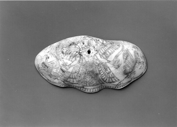 Shell engraved with winged female deity, sphinxes, and lotus plants