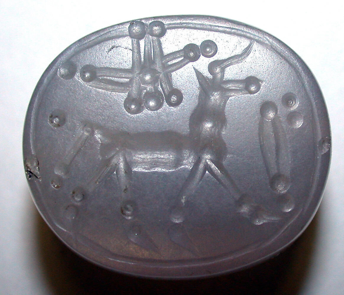 Stamp seal (scaraboid) with animal and divine symbols, Flawed neutral Chalcedony (Quartz), Assyrian 