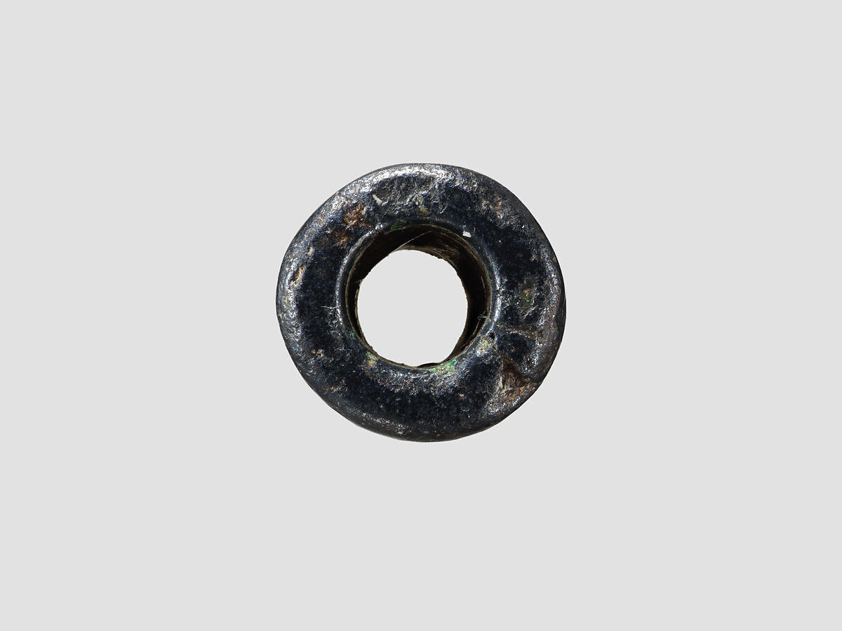 Cylinder seal and modern impression: palmette tree flanked by winged griffin and caprid; figure between them with raised hands; ingot, Hematite, Cypriot