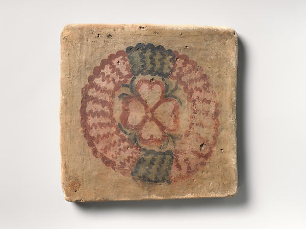 Tile with flower inside a wreath, Clay, painted plaster 