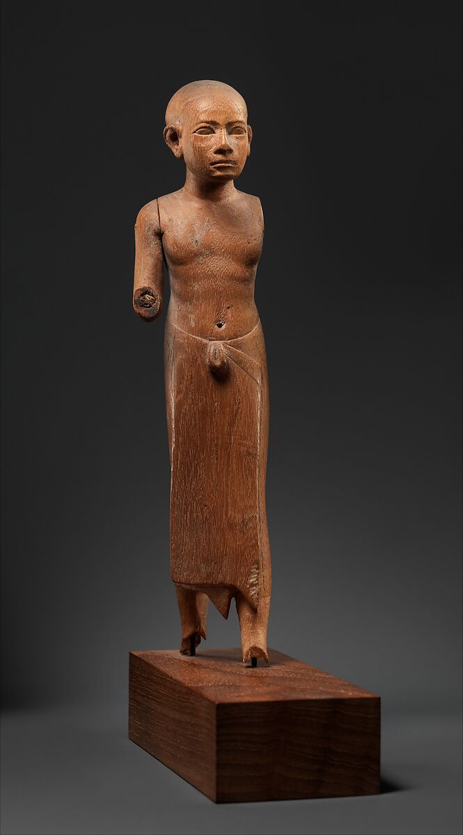 Figure of a Striding Man with a Long Kilt, Wood 