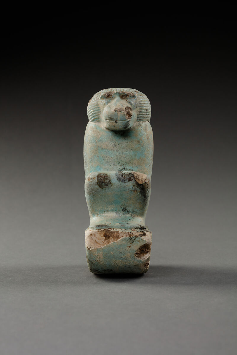 Figure of baboon on a basket and with a pillar, the shebet offering, Faience