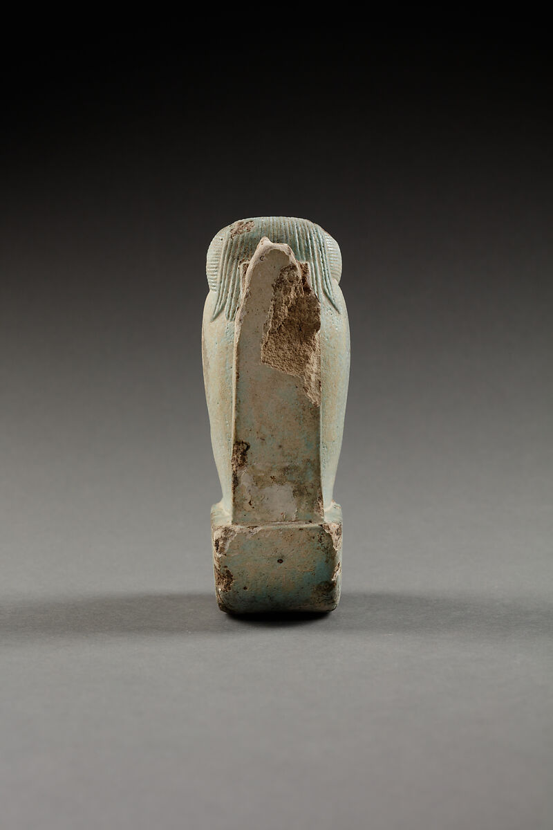 Figure of baboon on a basket and with a pillar, the shebet offering, Faience