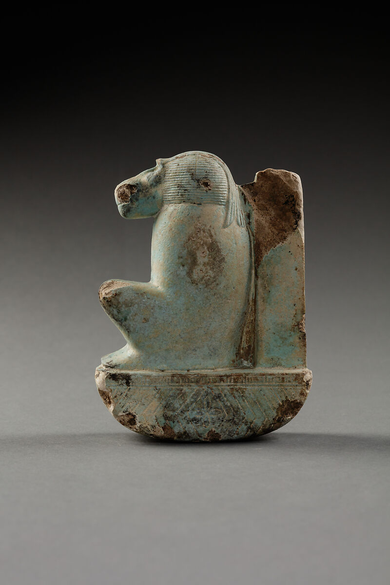 Figure of baboon on a basket and with a pillar, the shebet offering, Faience