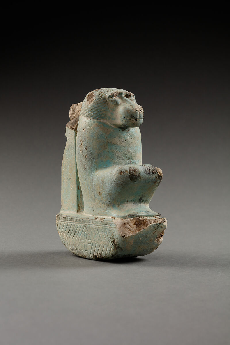 Figure of baboon on a basket and with a pillar, the shebet offering, Faience