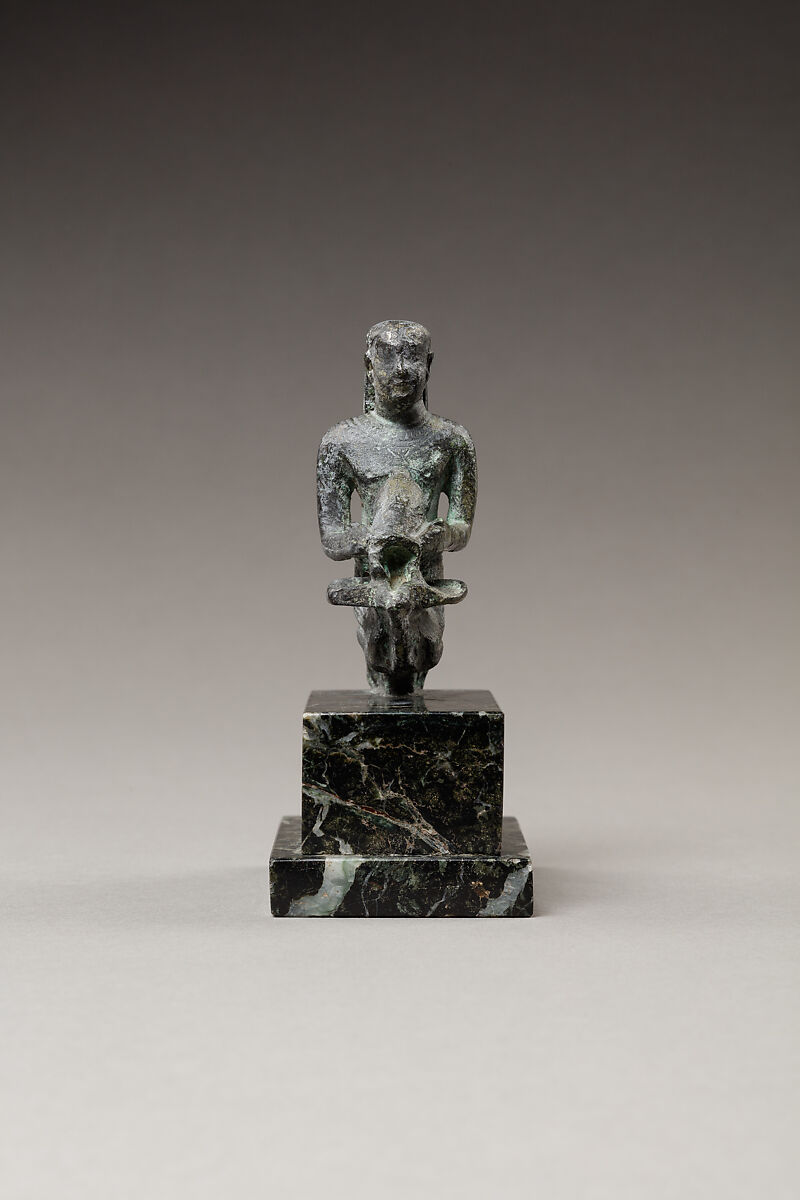 Pediese kneeling and pouring libation, Copper alloy