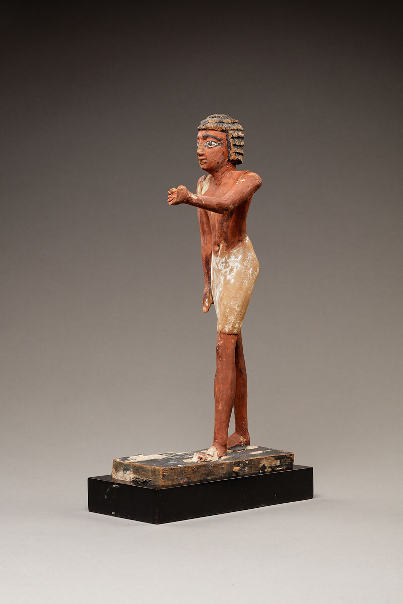 Statuette of a Striding Man in a Kilt, Wood, paint, pinkish colored paste