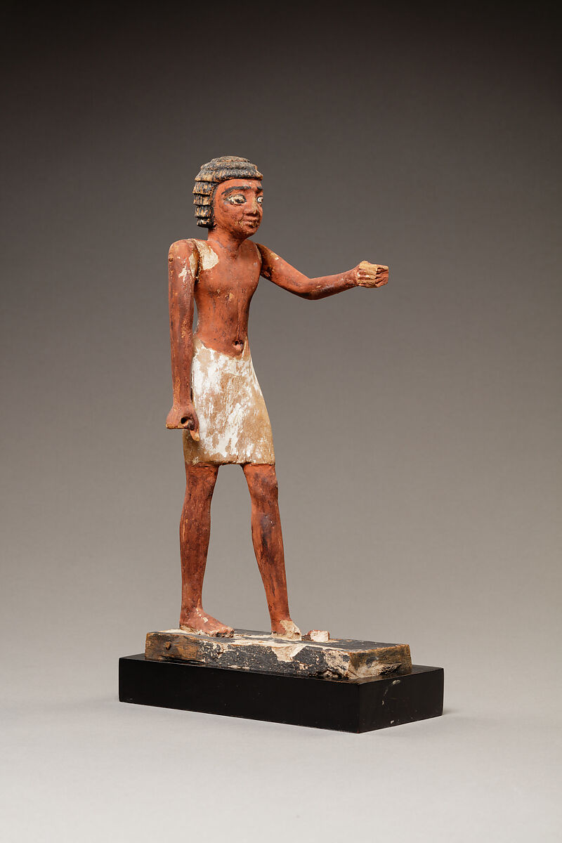 Statuette of a Striding Man in a Kilt, Wood, paint, pinkish colored paste 