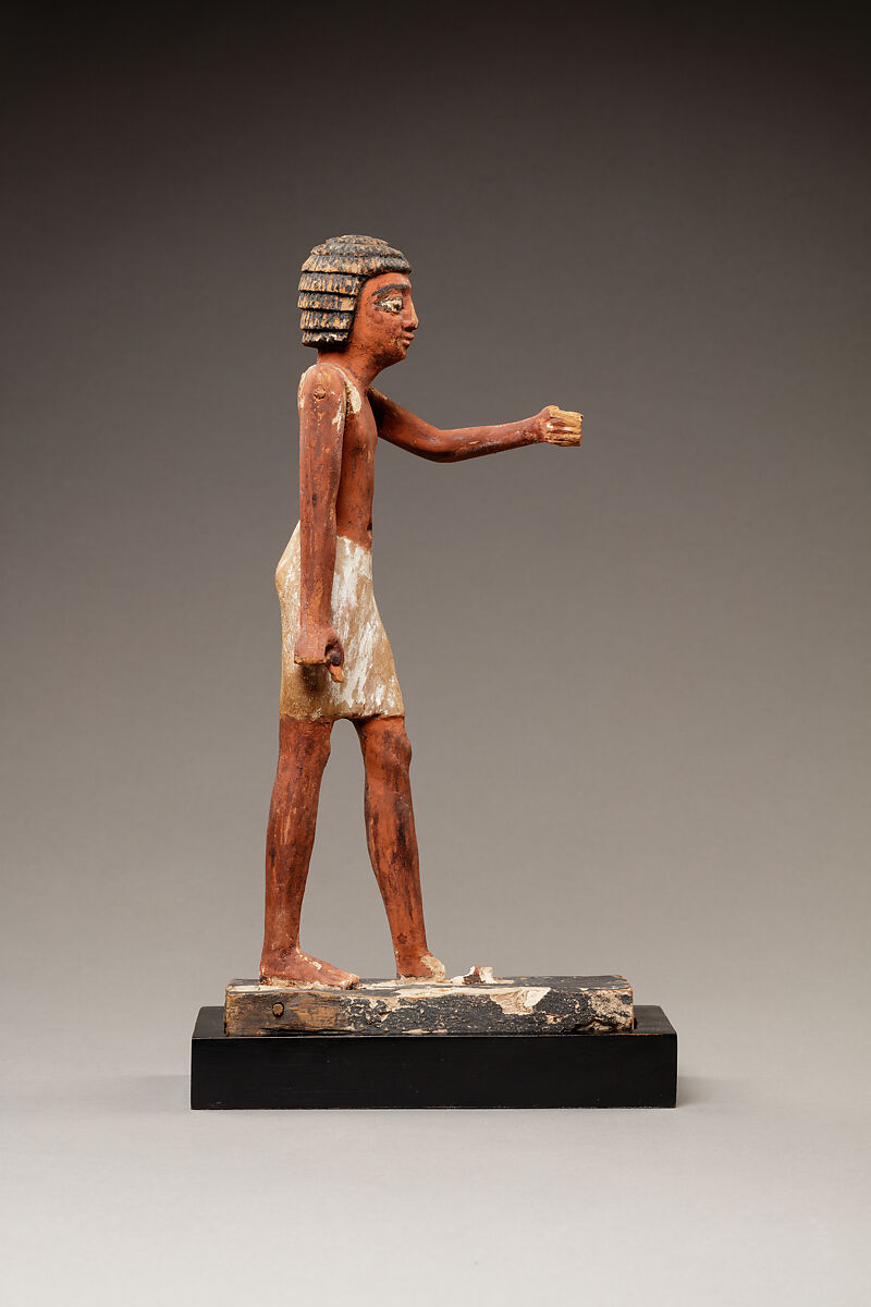 Statuette of a Striding Man in a Kilt, Wood, paint, pinkish colored paste