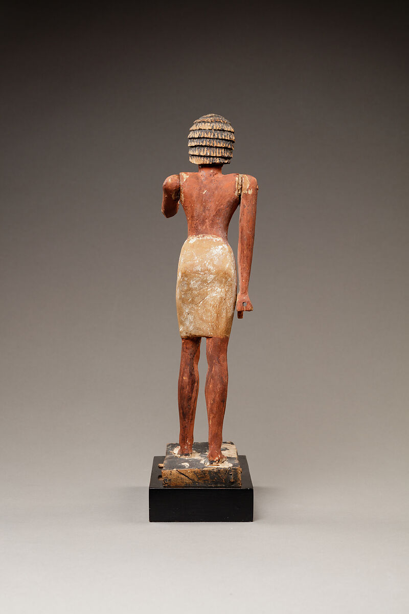 Statuette of a Striding Man in a Kilt, Wood, paint, pinkish colored paste