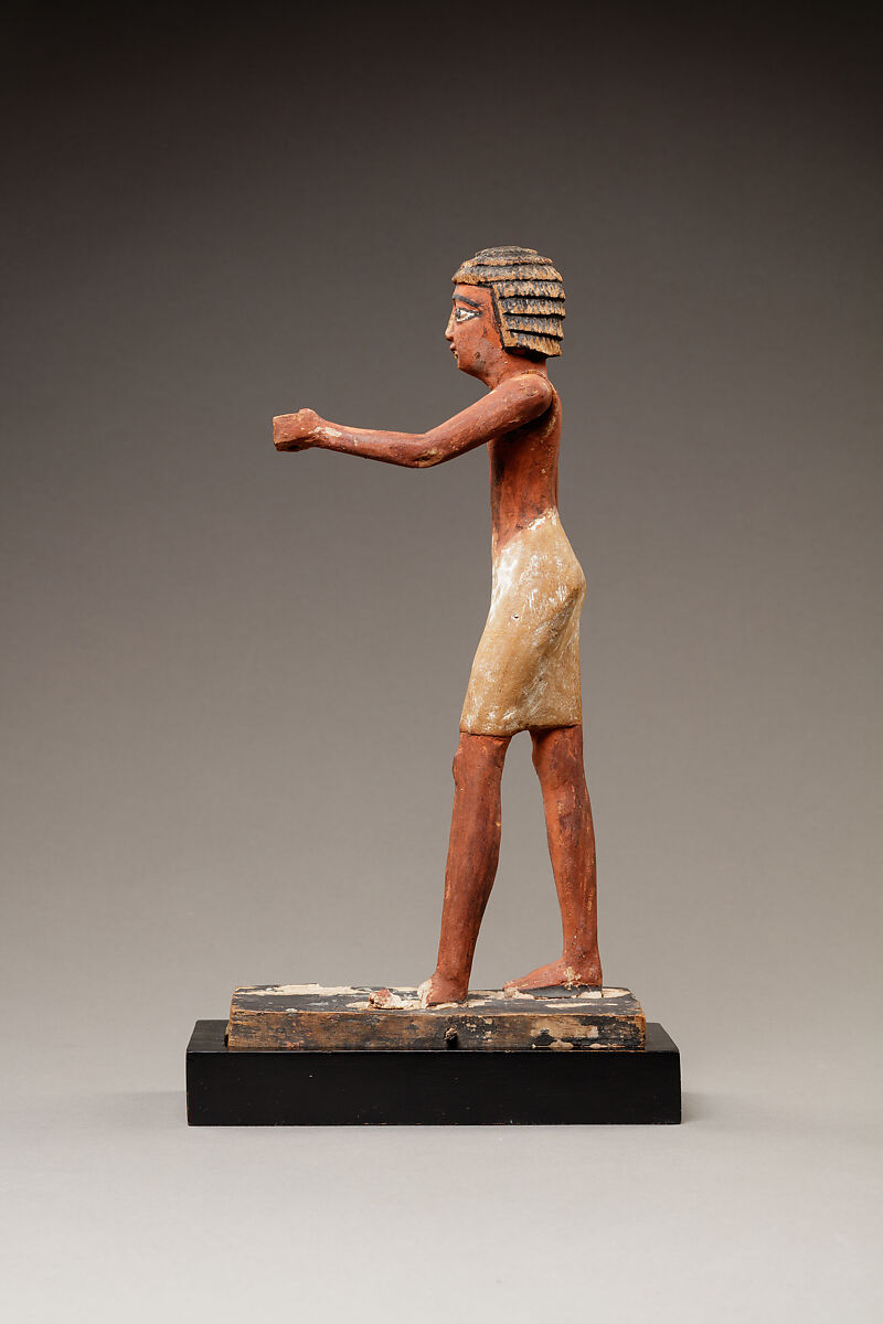 Statuette of a Striding Man in a Kilt, Wood, paint, pinkish colored paste