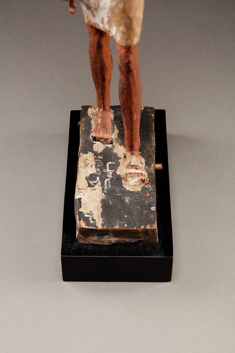 Statuette of a Striding Man in a Kilt, Wood, paint, pinkish colored paste