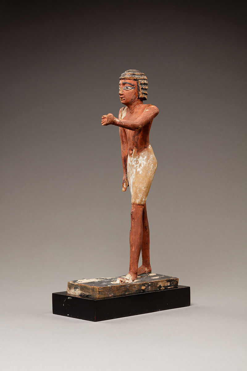 Statuette of a Striding Man in a Kilt, Wood, paint, pinkish colored paste