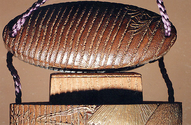 Case (Inrō) with a Fox from the Kyōgen Play "The Fox Hunter" (Tsurigitsune) (obverse); Haystacks and Stream from the Kyōgen Play "Hakuzosu" (reverse), Shibata Zeshin (Japanese, 1807–1891), Gold and colored lacquer on wood
Signed: Zeshin
Ojime: carved wooden dragon (signed: Ichiryūsai Furuta)
Netsuke: ceramic figure of Kaduzōsu (signed: Eiraku), Japan