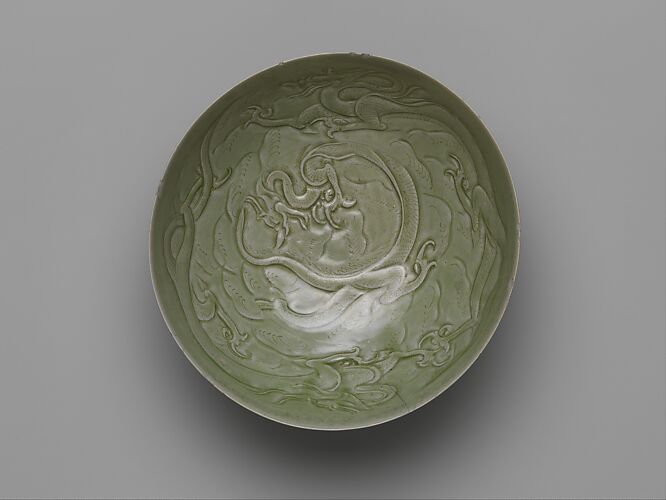Bowl with dragons amid waves
