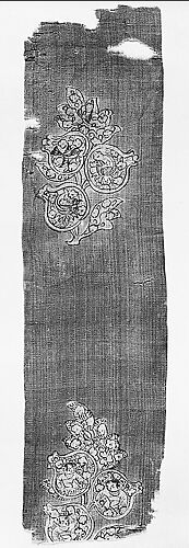 Textile fragment with boys and birds in pomegranates