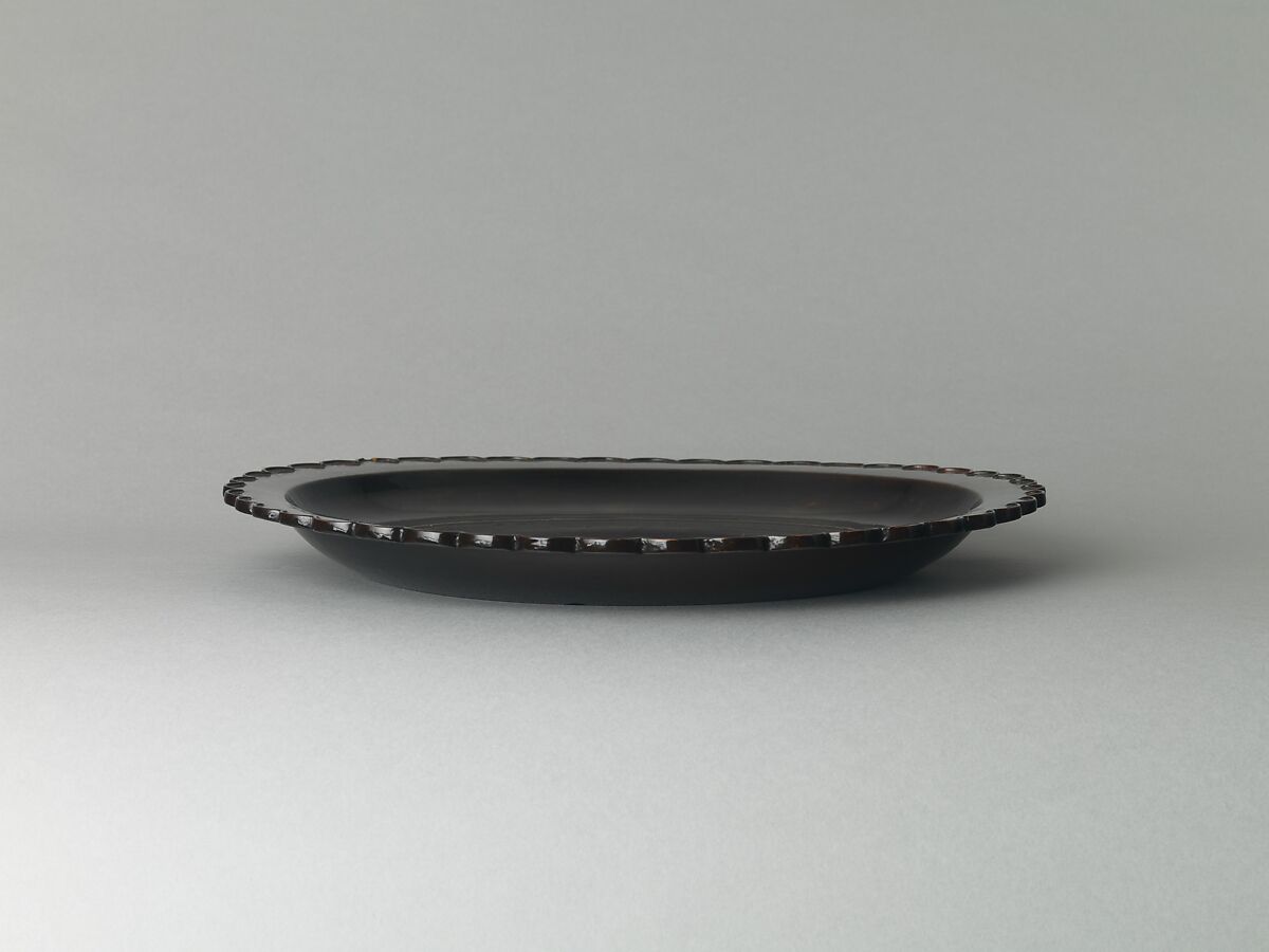 Dish with chrysanthemum-petal rim, Black lacquer with traces of gold decoration, China
