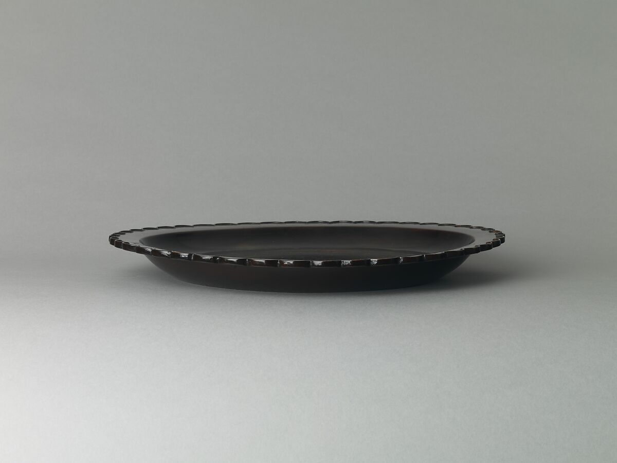 Dish with chrysanthemum-petal rim, Black lacquer with traces of gold decoration, China