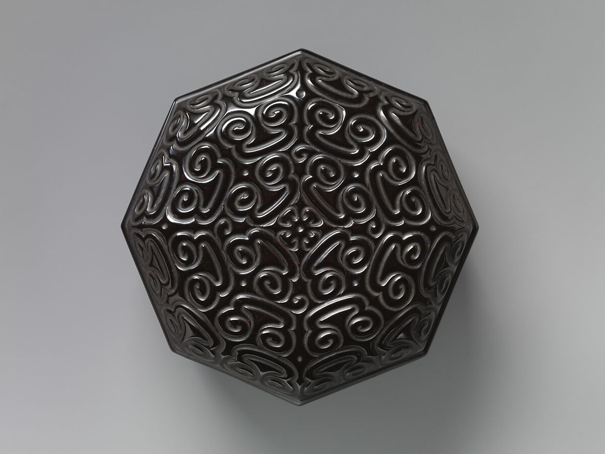 Octagonal box with pommel scrolls, Carved black lacquer with red layers (tixi), China