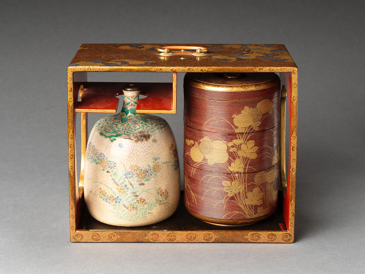 Picnic set with decoration of chrysanthemum and autumn grasses, Sprinkled gold and silver maki-e on red lacquer cabinet; sprinkled gold and black lacquer on red lacquer boxes; Kyoto-ware sake bottle (glazed stoneware with enamels), Japan