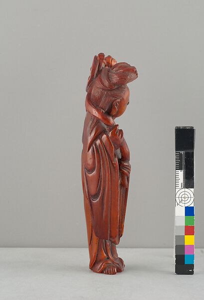 Standing Figure of Daoist Immortal (He Siengu), Amber, China