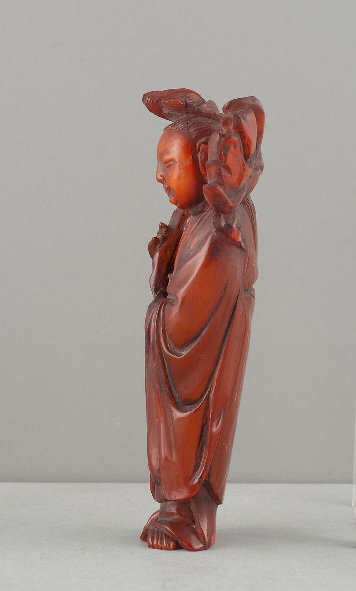 Standing Figure of Daoist Immortal (He Siengu), Amber, China